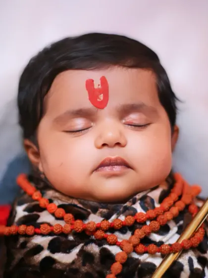 A perfectly centered shot of the sleeping baby in the 'Little Shiva' theme.