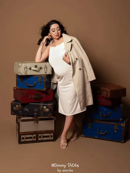 This shot showcases a relaxed yet poised look. The makeup is understated, proving that you can look glamorous and feel comfortable during your maternity shoot.