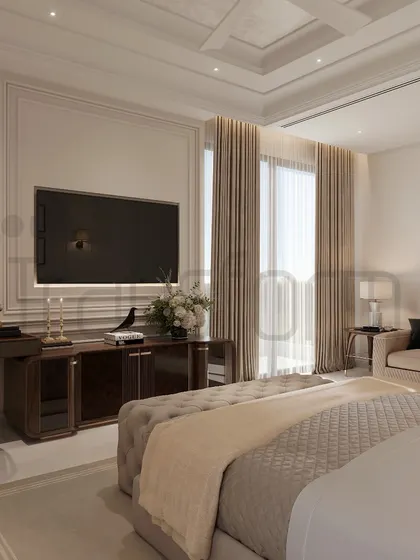 This bedroom is designed to be a reflection of the soul, graced with timeless elegance. The space includes a comfortable seating area and a dedicated workspace, all unified by a calm, neutral palette and classic wall paneling.