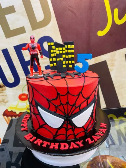 Your friendly neighborhood Spider-Man, ready for action. This 3kg cake features the iconic red web design, a city skyline, and a Spider-Man figurine on top.