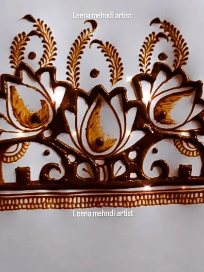 An intricate design combining lotus flowers and small elephants. This is a beautiful example of a symmetrical cuff or armband pattern.