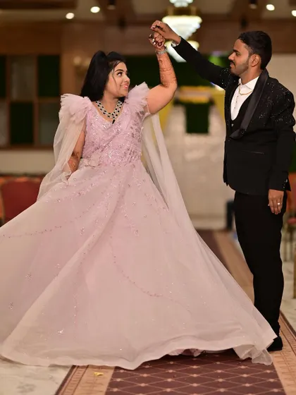 A dance to celebrate their new beginning. This couple looks so happy, with the bride twirling in a beautiful light pink ball gown at their engagement party.