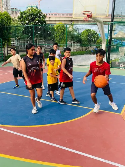I'm providing one-on-one feedback to a junior player during a dribbling drill.