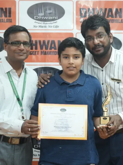 A student receives his award from his proud teachers.