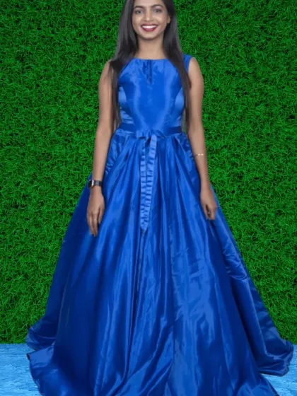 A royal blue satin ball gown with a built-in belt. The rich color and shiny fabric make this a truly regal and eye-catching piece.