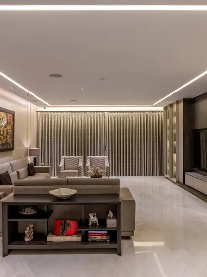 A view of the media zone in this BKC residence, where clean lines and integrated lighting create a sophisticated entertainment hub. The custom shelving and console maintain a sleek, uncluttered look.
