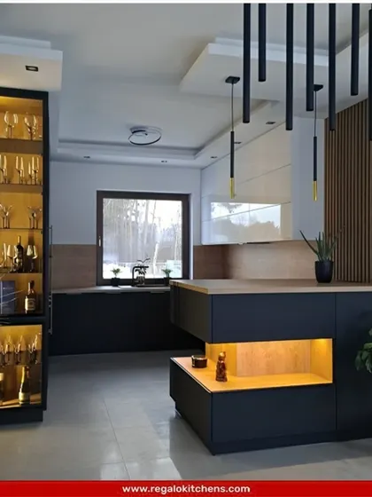 A unique island kitchen design featuring a tall, glass-fronted wine and glassware cabinet. The black and wood-paneled island includes open shelving, creating a perfect balance of display and storage in a modern, stylish layout.