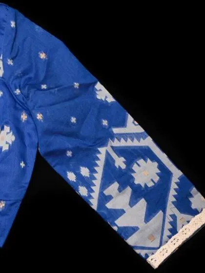 A close-up of the sleeve of our blue Jamdani cotton blouse, highlighting the intricate handloom pattern.