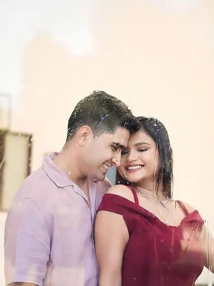 A creative shot of a couple behind a rain-swept window. Our sets allow for artistic effects like this to add a unique, romantic touch to your pre-wedding photos.