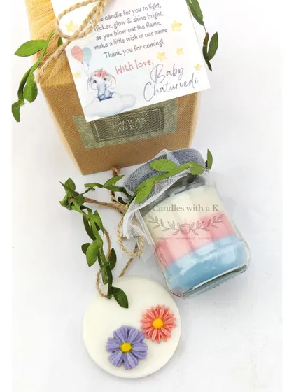 Another view of the baby shower gift box, highlighting the layered candle and floral sachet.