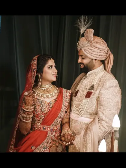 A candid, happy moment between the bride and groom, their smiles lighting up the frame. This is the kind of authentic emotion we strive to capture.