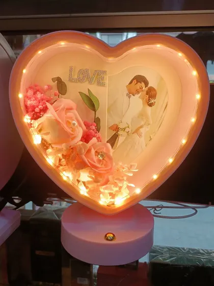 This pink heart-shaped LED lamp is another lovely option. It features delicate pink roses and a 'Love' sign, perfect for Valentine's Day or an anniversary.