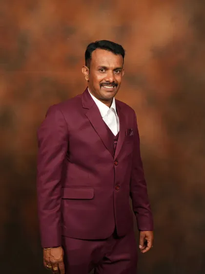 A proud father in a custom maroon three-piece suit, part of a father-daughter coordinated set.