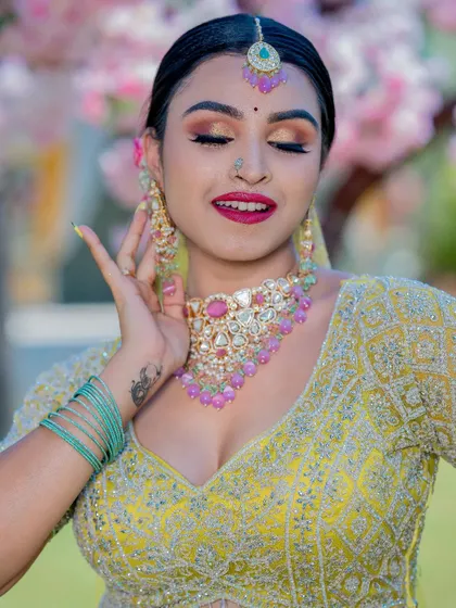 A close-up of the eye makeup for the yellow lehenga look. The golden shimmer on the eyelids and the perfectly blended eyeshadow make her eyes stand out beautifully.