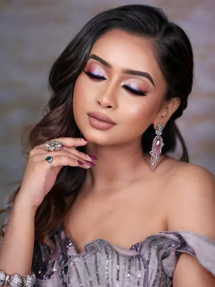 This image showcases a beautiful blend of pink and purple eyeshadows with a sharp, holographic liner. Students learn how to blend colors seamlessly and create sharp lines for a professional finish.