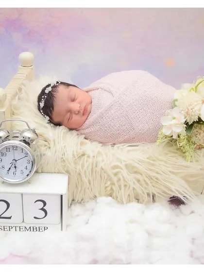 A dreamy, celestial-themed portrait with the baby sleeping on a bed of clouds. The calendar block and clock are perfect for creating a personalized birth announcement.