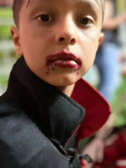 A direct look from our little vampire, showing off his impressive and spooky makeup. He's ready for his close-up.