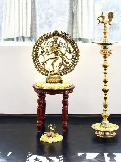 The beautiful brass Nataraj idol and a traditional lamp, or 'diya', in my studio. These elements bring a sense of sacredness and tradition to our modern space, grounding our practice in ancient wisdom.