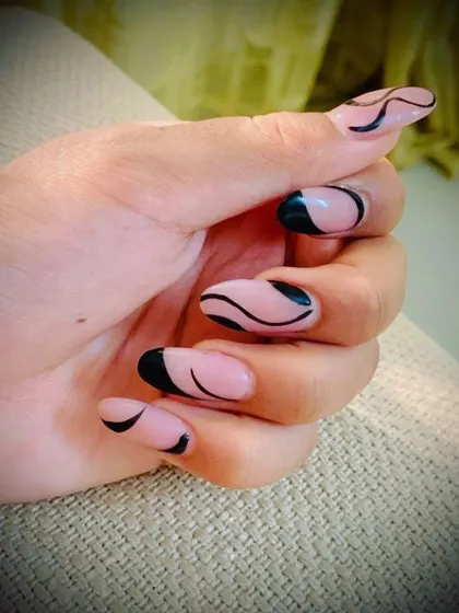 Another angle of this abstract black line art on almond-shaped nails. The clean lines and negative space create a very chic and contemporary feel.