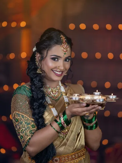 This happy portrait captures the festive spirit. The jewellery adds a touch of tradition and sparkle.