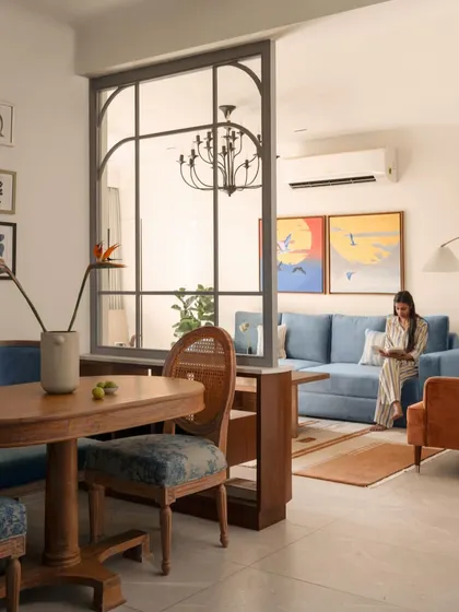 To create a sense of separation without sacrificing light, I installed a glass and metal partition between the dining and living areas. This defines the two zones while maintaining an open, airy feel perfect for entertaining.