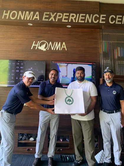 A Participant Receiving a Prize at the Men's Golf Camp: Every participant's effort is valued. Here, a golfer receives a prize from our instructors, marking the successful conclusion of our engaging and skill-building Men's Golf Camp.