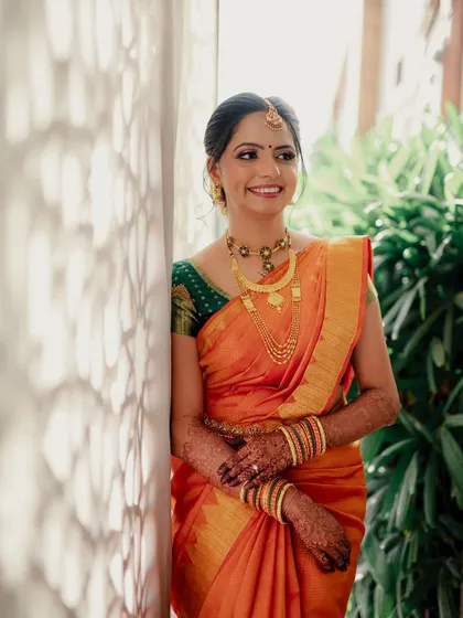 A happy bride glowing with excitement. Her makeup is designed to be radiant and picture-perfect, ensuring she looks flawless in every photograph.