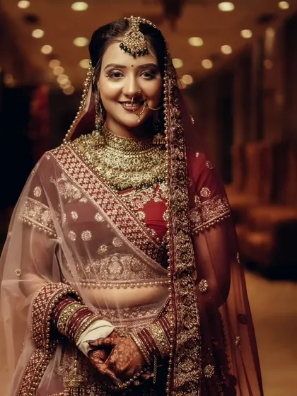 A classic, smiling bridal portrait, capturing the bride's happiness and the elegance of her wedding attire.
