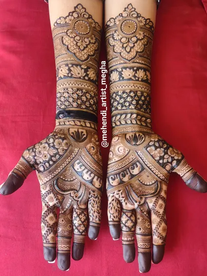 This design is a beautiful example of symmetry and contrast. The dark, filled-in floral bands on the arms make the intricate patterns on the hands pop, with elephant and lotus motifs adding a traditional touch.
