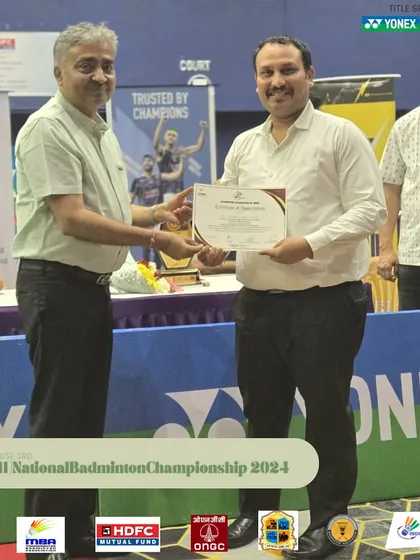 An umpire being presented with a certificate of appreciation. I ensure that all technical officials are treated with respect, which helps in attracting the best officials for my tournaments.