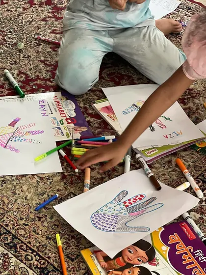 A floor full of colorful markers and pattern drawings. This activity is all about letting go and exploring different lines, shapes, and designs.