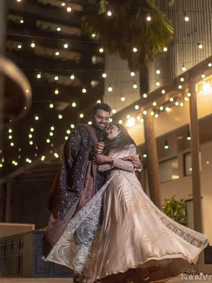 A romantic dance under a canopy of fairy lights. This night shot captures the magic and celebration of an engagement, with the bride's flowing dress adding a beautiful sense of motion.