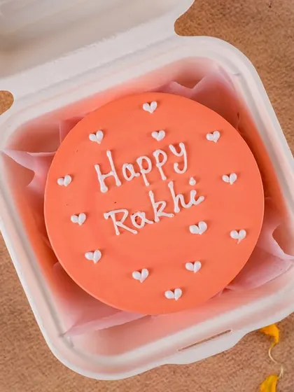 A simple and heartfelt "Happy Rakhi" bento cake. The bright color and minimalist heart design make it a cheerful and sweet gift for your sibling.