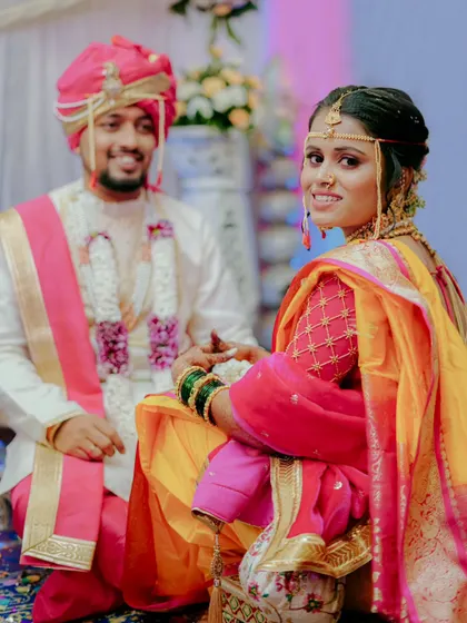 The bride looks over her shoulder with a gentle smile during the wedding ceremony.