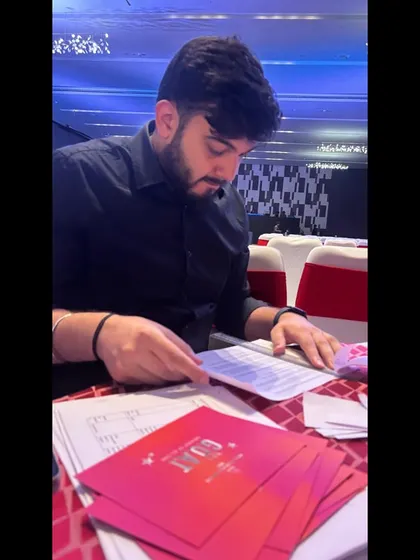 A team member reviewing the event credentials and show flow documents for the Myntra awards.
