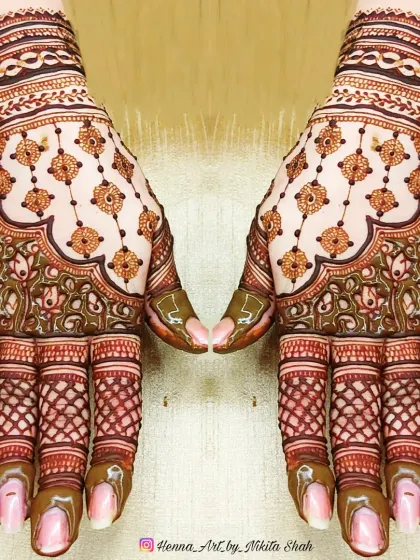 A beautiful designer back-hand mehendi. The hanging motifs and delicate net pattern create a very graceful and stylish look.