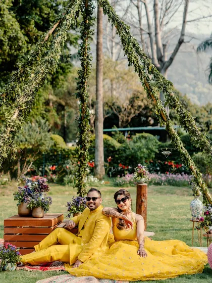 A relaxed and stylish portrait from a picnic-themed setup. The couple's cool demeanor and coordinated outfits create a modern and fun vibe. This shows how we can incorporate props and setups to match your personality.