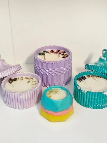 A stunning custom order of personalized candles. This set includes a large diamond jar, two fluted jars with lids, and a small hexagon candle, all in different colors and designs as requested by the client.