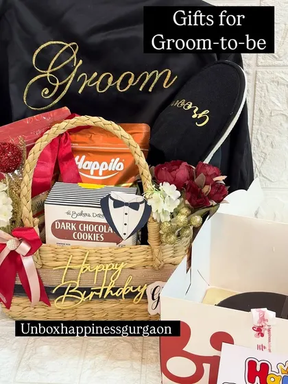 Celebrating the groom-to-be with a custom birthday hamper. This gift includes a personalized 'Groom' robe, matching slippers, his favorite snacks, and a birthday cake, making it a perfect gift for a double celebration.