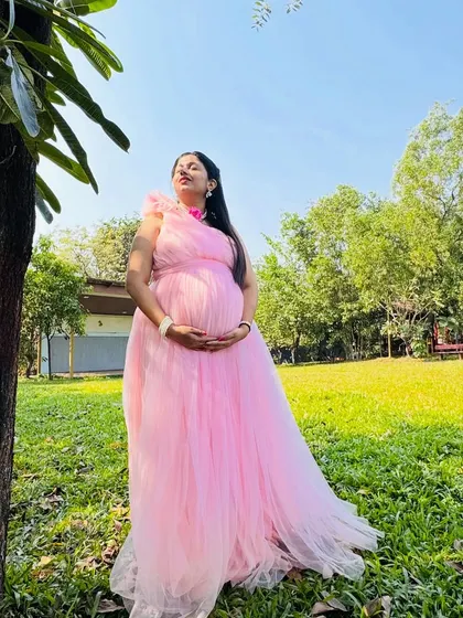 A beautiful mom-to-be enjoying the sunshine in this flowing pink tulle gown. It's one of my most popular rentals for outdoor maternity shoots.