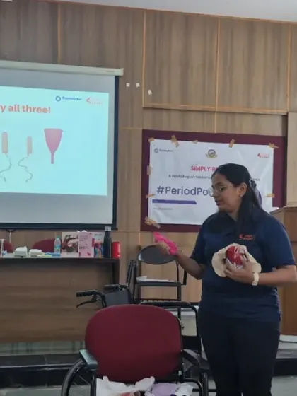 A facilitator uses a pelvic model to explain the female reproductive system during our para-athlete workshop. We use visual aids to make complex topics accessible and help athletes understand their bodies better.
