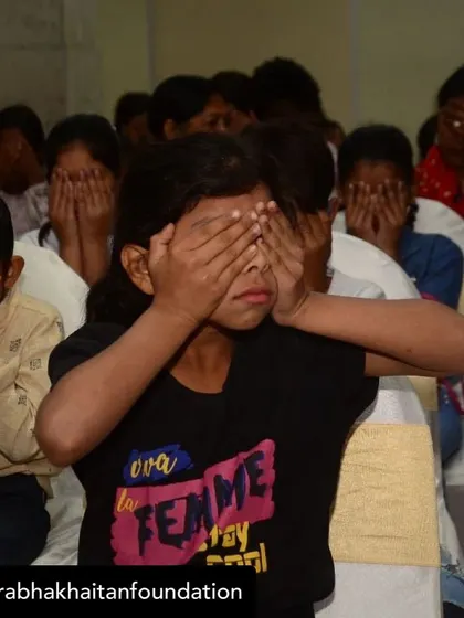 Children in a workshop for a marginalized community cover their eyes during a suspenseful part of a story. Storytelling is a universal language that creates shared experiences and emotions.