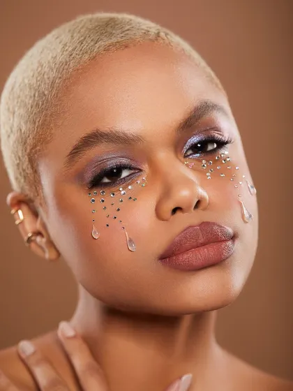 An ethereal and emotional look with glitter "tears" falling from the model's eyes. This is storytelling through makeup.