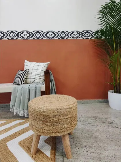 A straight-on shot of the custom-painted border, which provides a sharp contrast against the terracotta-colored wall.