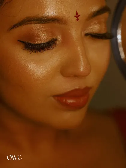 An extreme close-up on the bride's flawless makeup and serene expression.