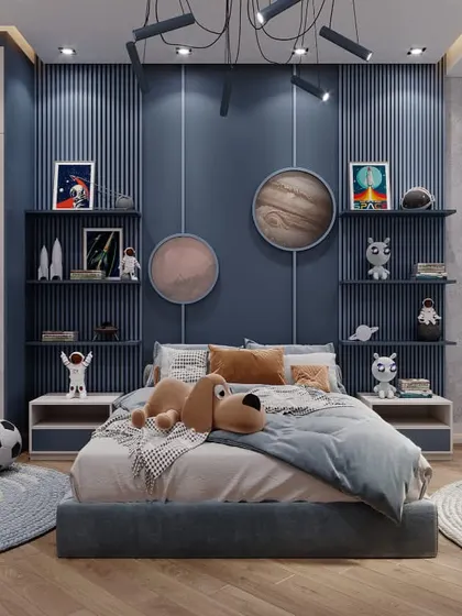 A bedroom for a budding astronaut, this space-themed design features a planet-inspired accent wall, custom shelving for collectibles, and a cozy bed ready for cosmic dreams.