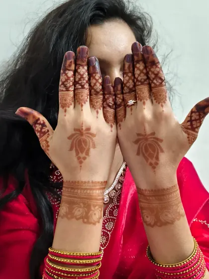 The simple joy of Chhath Puja captured in this photo. A client showing off her minimalist lotus mehndi, radiating desi charm.