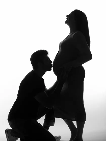 A full-body silhouette of a couple's tender moment. This style of photography creates a powerful and emotional image, focusing entirely on the shape and connection.