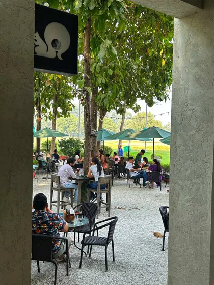 A view of the bustling patio from the cafe entrance, with our squirrel logo visible.