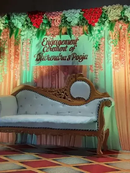 A simple and sweet engagement stage for the ceremony of Dhirendra and Pooja. The peach and green color combination with floral details is perfect for a daytime function.
